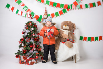 boy near a Christmas tree on a white background.