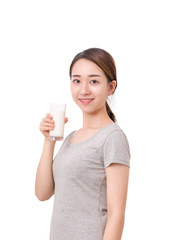 Woman drinking milk. Happy and smiling beautiful young woman enjoying a glass milk.