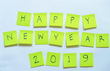 yellow paper note writing happy new year 2019 stick on white background