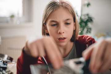 Girl modifying power supply and  learning robotics