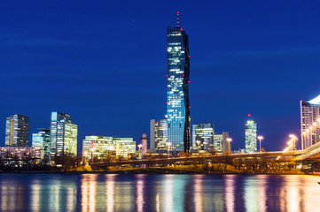 Obraz premium Modern part of Vienna Austria, with skyscrapers on the Danube with reflect in the water