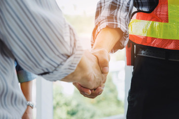 engineers and technician contractor shaking hands after finishing up a business meeting to greeting start up project contract in construction site building, successful, partnership, teamwork concept