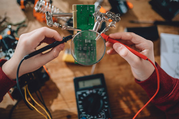 Girl using multimeter