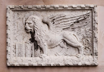 Stone bas-relief of the Venetian lion on one of the houses of Venice. The lion of St. Mark is a symbol of the city of Venice, and one of the elements of the flag of the Italian fleet.
