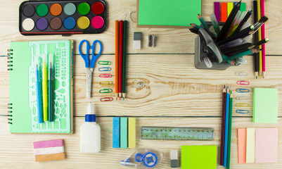 Frame with school supplies on a wooden background. Flat lay, top view
