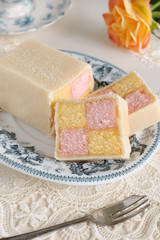 Battenberg Cake or Battenberg Square a sponge cake with pink a yellow checks covered in marzipan