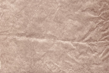 The brown blank crumpled and grungy textured paper background