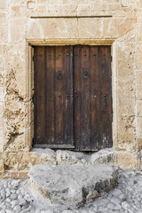 Fototapeta na wymiar A low door in Greek village