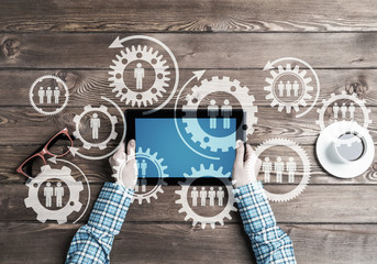 Concept of teamworking and connection with gears mechanism and tablet pc