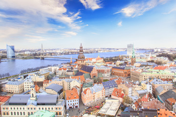 Naklejka premium eautiful view of the old town and the steeple of the Dome Cathedral near the Daugava River in Riga, Latvia