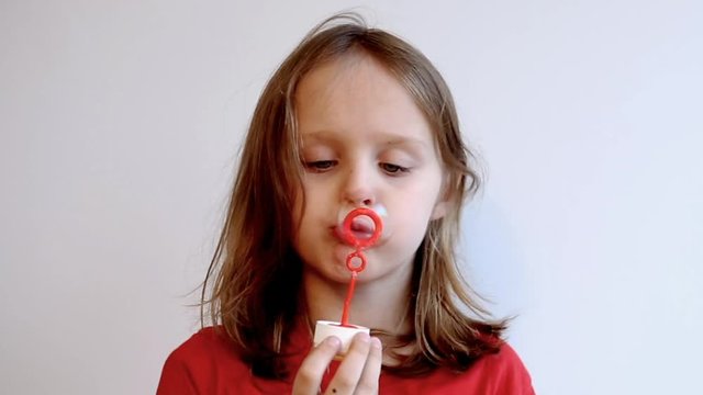 Cinemagraph of young boy blowing soap bubbles
