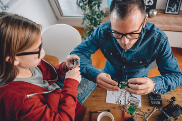 Father and daughter working together in workshop
