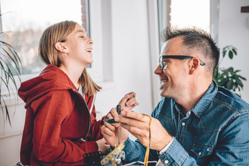 Father and daughter working together in workshop