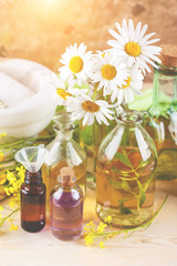 Fototapeta na wymiar Essential oils and wild flowers