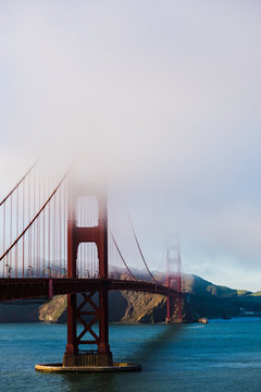 The phases of the Golden Gate Bridge in San Francisco is getting covered with fog and/or cloud