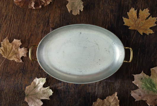 Vintage frying pan wooden background dry autumn leaves, top view