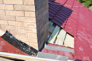 Roofing Construction. Repair roof with  insulation and waterproofing chimney area.