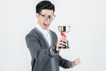 Nerd man winning big. Young Asian nerd man holding a trophy, smiling, winning pose while standing isolated in white background