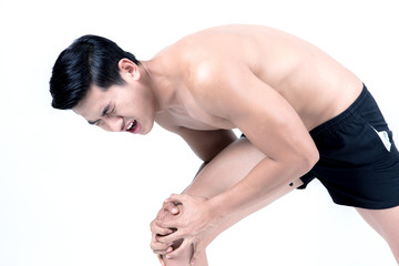 Obraz premium Fitness and health concept. Fit sport man having knee injury, isolated on white background in studio. Half naked Asian chinese lean muscular male wearing a black shorts.