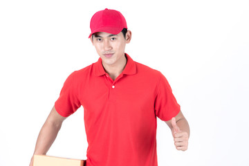 Young logistic career concept. Happy delivery man with box and thumbs up. Isolated on white background. Asian chinese fit man in red polo shirt and jeans with red hat in his early twenties.