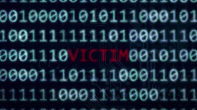Victim red text glowing on blue random binary code screen