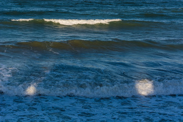 Two Spots of Light On the Waves