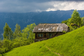 Fototapeta na wymiar A Deserted Wooden House in the Stormy Mountains