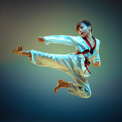 Young boy training karate on blue background © master1305