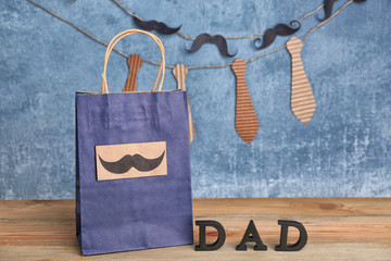 Paper bag with gift for Father's day on table