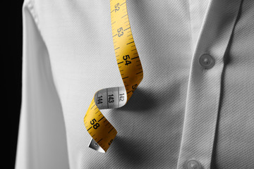 Elegant custom made shirt with measuring tape, closeup