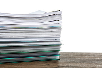 Stack of documents on table against white background