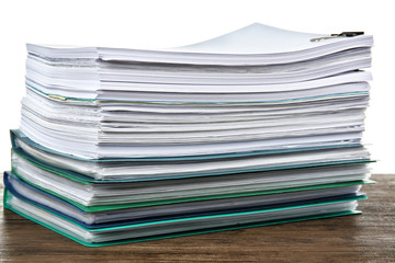 Stack of documents on table against white background