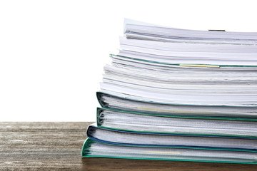 Stack of documents on table against white background