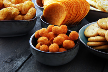Salty snacks. Pretzels, chips, crackers in bowls