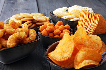 Salty snacks. Pretzels, chips, crackers in bowls