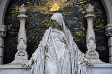 Guardian angel protecting a tomb
