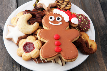 Santa claus cookie and Plate with tasty fresh Christmas cookies on  table