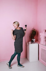girl with a phone on a pink background