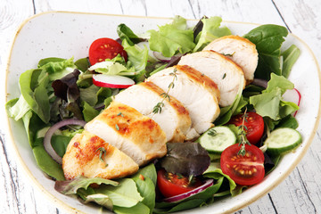 Chicken salad with leaf vegetables and cherry tomatoes.