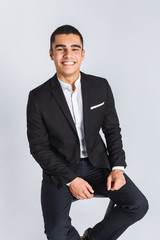 Portrait of the beautiful posing in a Studio, White background, Stylish business man, Stylish man sitting on a designer chair
