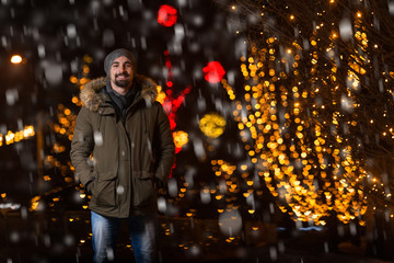 Cheerful Man Dressed Warm at Christmas Tree