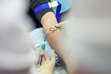 The doctor takes blood from veins