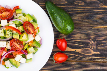 Dietary salad of fresh vegetables with avocado and goat cheese