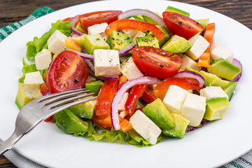 Dietary salad of fresh vegetables with avocado and goat cheese