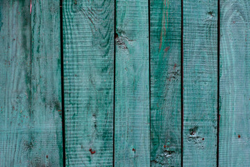 Fototapeta na wymiar Background of natural knotted wood fence. Wooden texture.