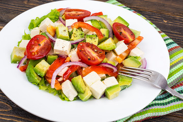 Dietary salad of fresh vegetables with avocado and goat cheese