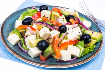 Greek salad with feta, avocado and black olives