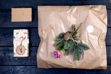 Christmas gifts of different sizes on a dark wooden background