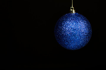 blue christmas ball on black background