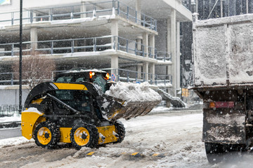 Machine remove snow from a city street